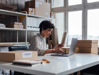 Woman in office surrounded by boxes